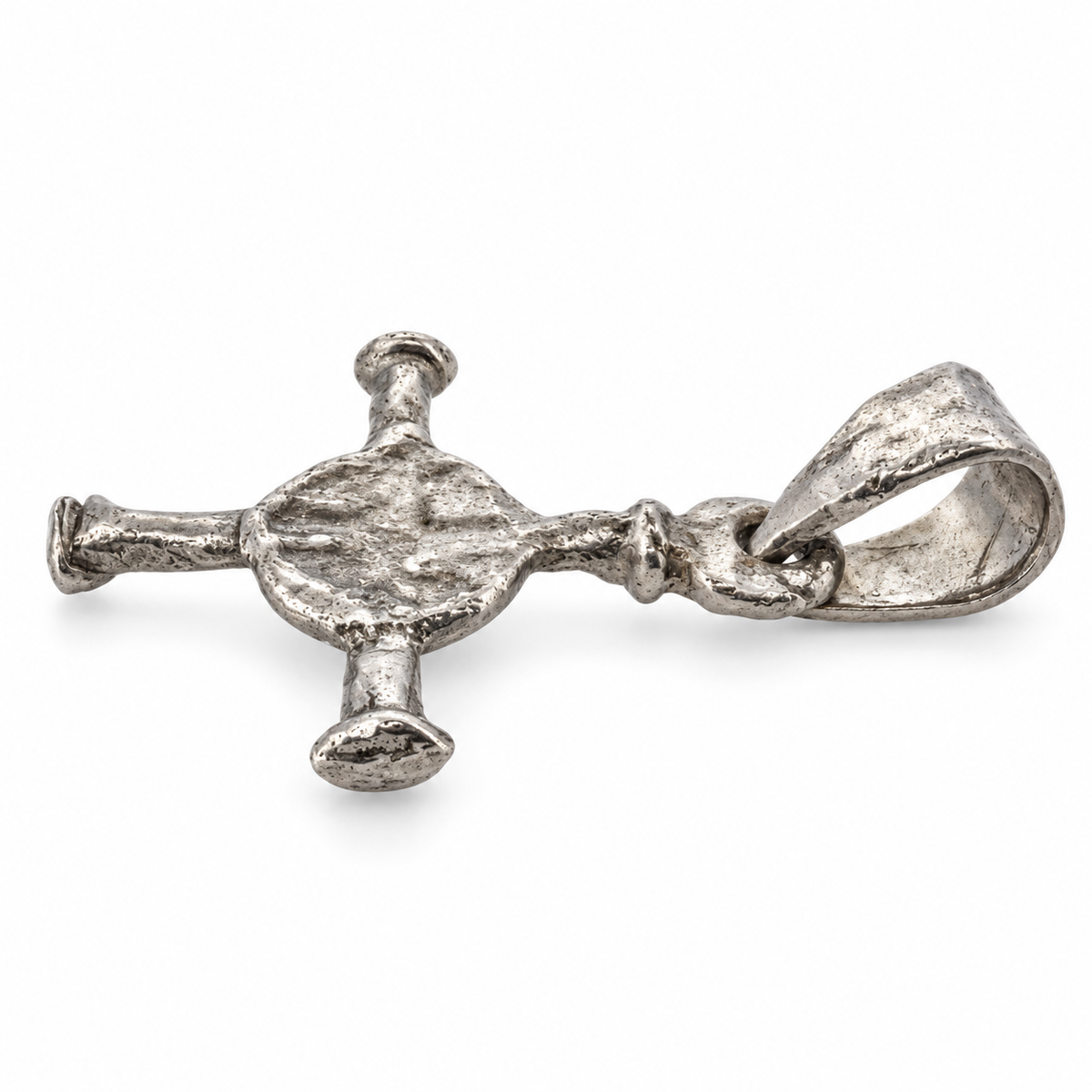 Platinum Anglo-Saxon cross pendant from Northumbria, angled view.