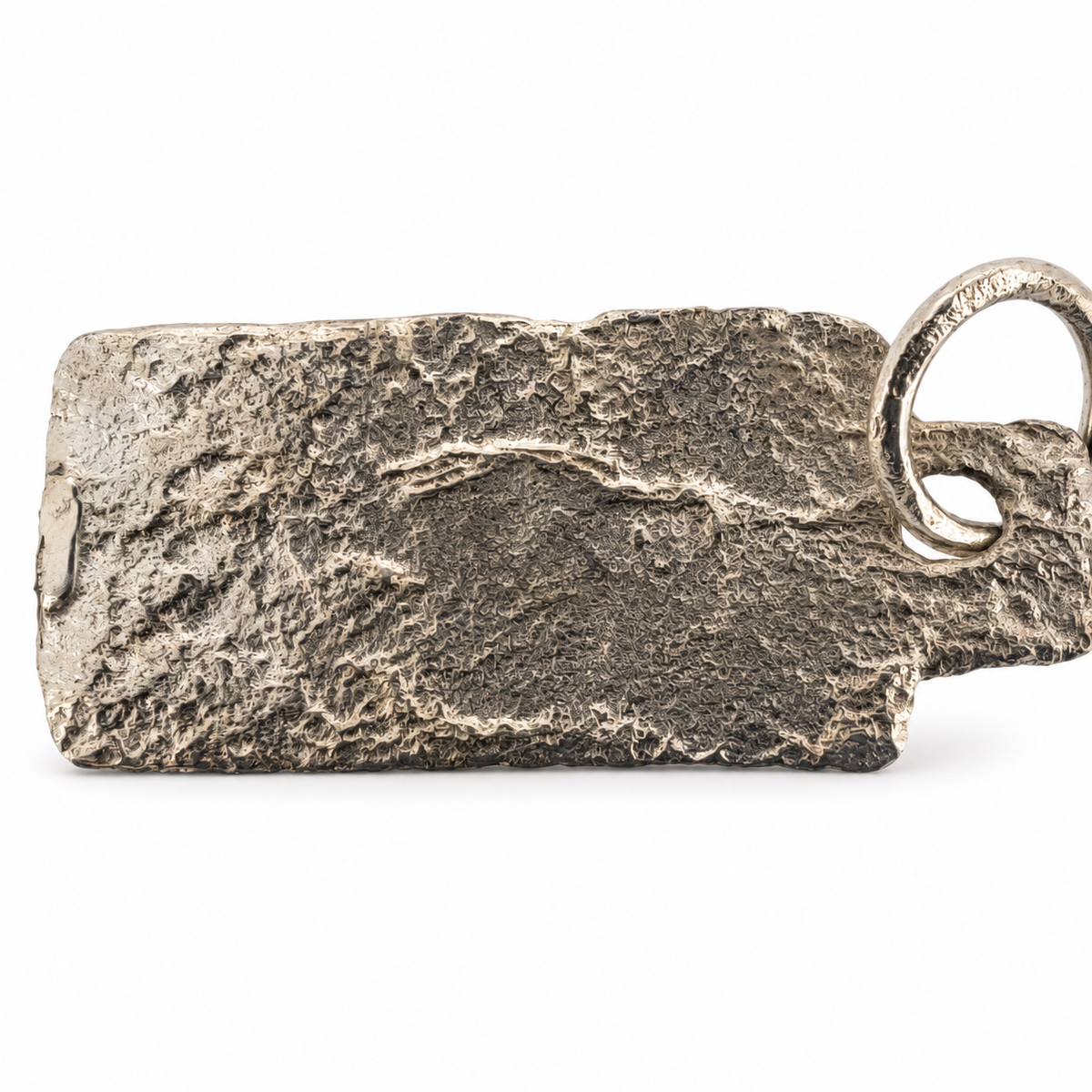 Silver early medieval bicorporate lion pendant from Hertfordshire, reverse view.