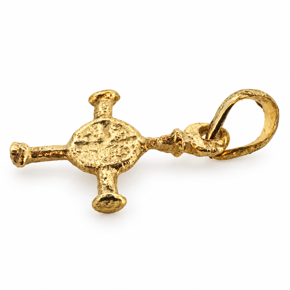 Gold Anglo-Saxon cross pendant from Northumbria, angled view.