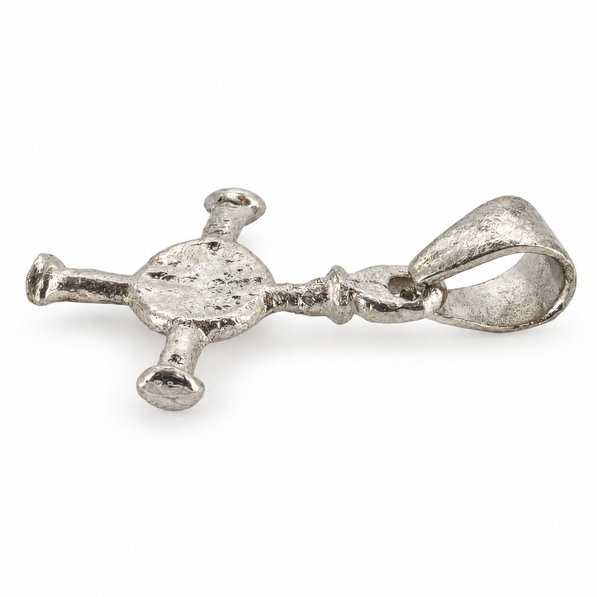 Silver Anglo-Saxon cross pendant from Northumbria, angled view.