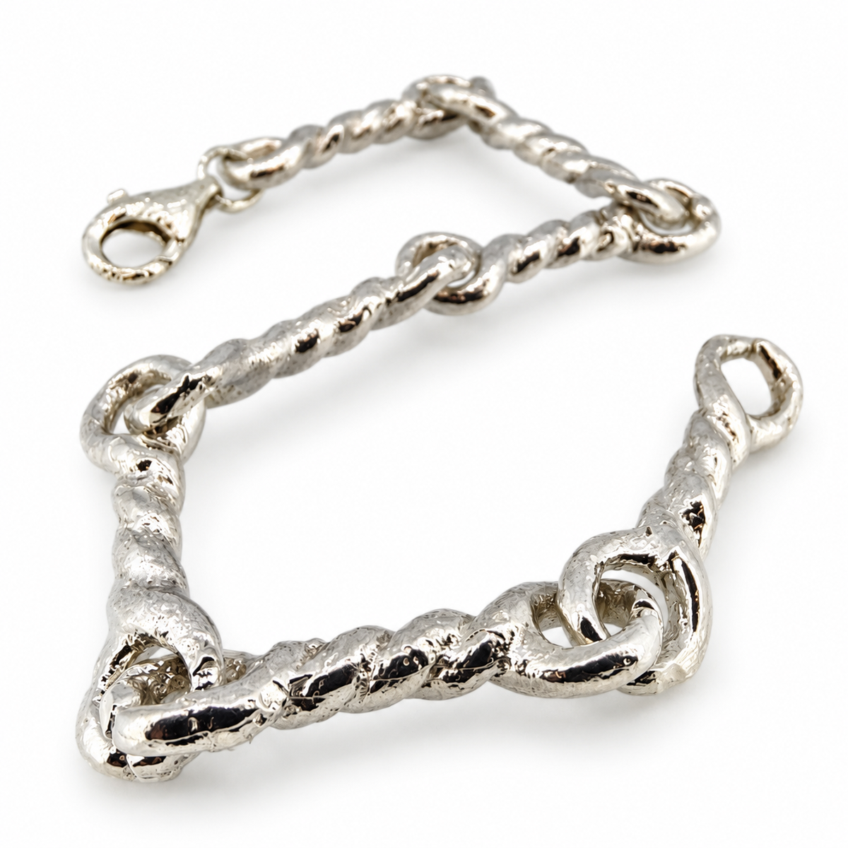 Silver North Yorkshire Early Medieval twisted-link bracelet, angled view.